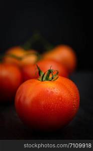 Still life of fresh ripe tomatoes on wooden background, Choose focus point. Good health concept. Vertical picture style.
