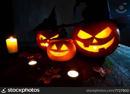 Still life of Halloween pumpkin lanterns pumpkins and hats decoration in candle light. Halloween pumpkin lanterns