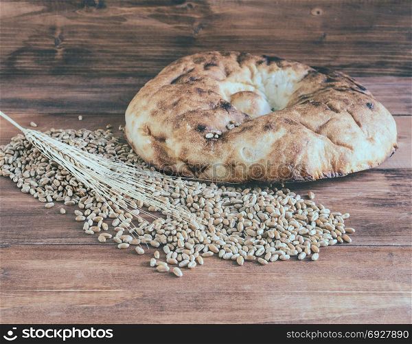 Still life of pita bread and ears of wheat