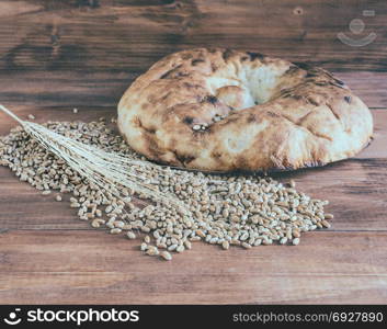 Still life of pita bread and ears of wheat