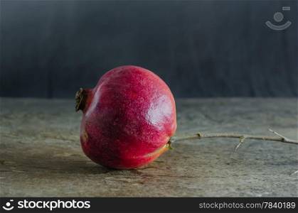still life of pomegranate on wooden background. pomegranate