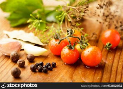 Still life of preserving tomatoes on wooden table in kitchen