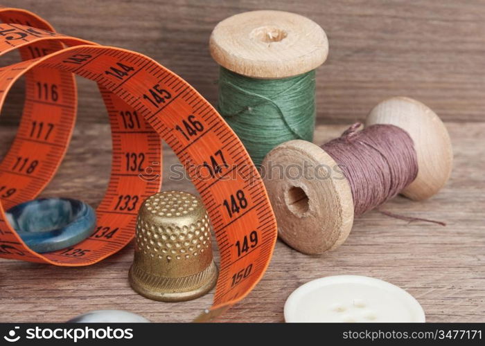 still life of spools of thread on a wooden background