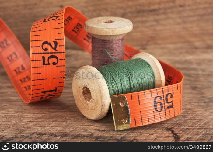 still life of spools of thread on a wooden background