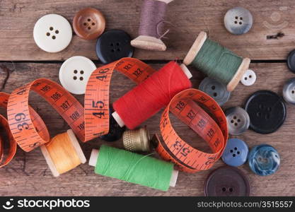 still life of spools of thread on a wooden background