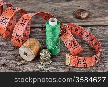 still life of spools of thread on a wooden background