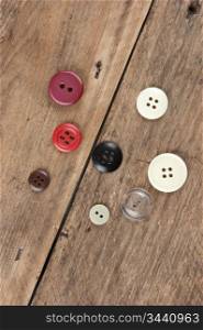 still life old buttons on a wooden board