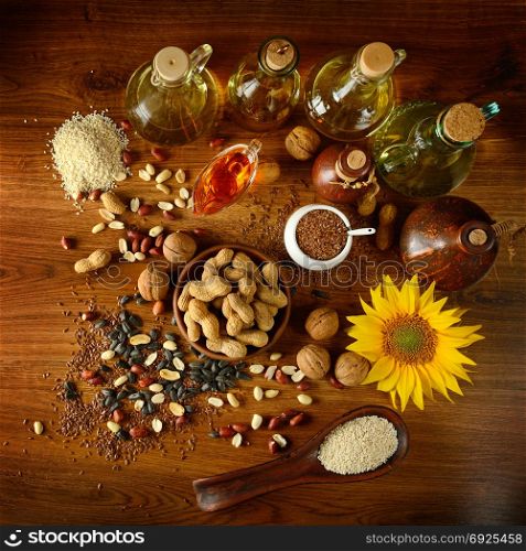 Still life seeds and oils useful for health (Flax, sesame, sunflower, olives, walnut, peanuts). Top view.