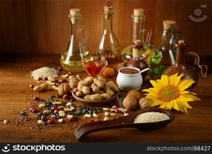 Still life seeds and oils useful for health (flax, sesame, sunflower, olives, walnut, peanuts)