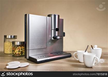 Still life with a domestic pad coffee machine on a wooden surface, country styled