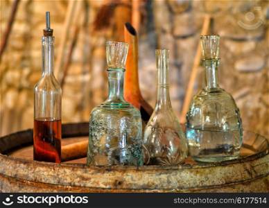 Still life with antique utensils for wine and brandy in the ancient wine cellar on the old oak barrel