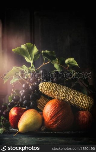 Still life with autumn fruits and vegetables, dark, vintage styled