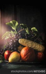 Still life with autumn fruits and vegetables, dark, vintage styled