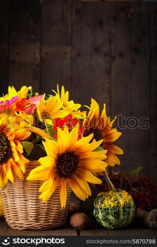 Still life with autumn harvest on wood background. Still life in colours of autumn