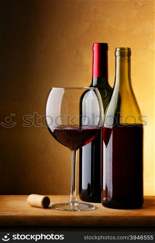 Still-life with bottle of red wine and glass