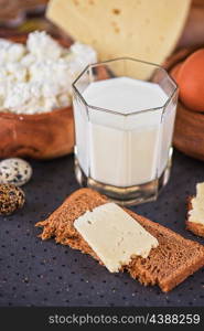 still life with dairy products as milk, cheese cottage cheese eggs and bread