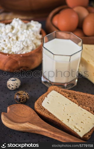 still life with dairy products as milk, cheese cottage cheese eggs and bread