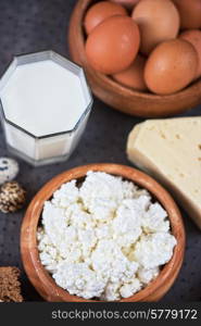 still life with dairy products as milk, cheese cottage cheese eggs and bread