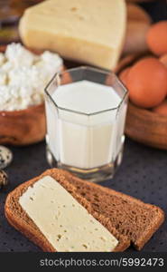 still life with dairy products as milk, cheese cottage cheese eggs and bread