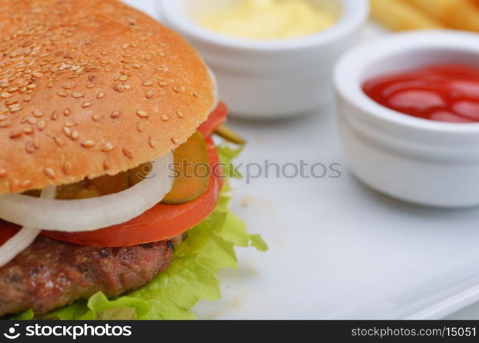 still life with fast food hamburger menu, french fries, soft drink and ketchup