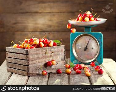 still life with fresh cherries on wooden background