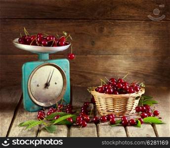 Still life with fresh cherries on wooden background