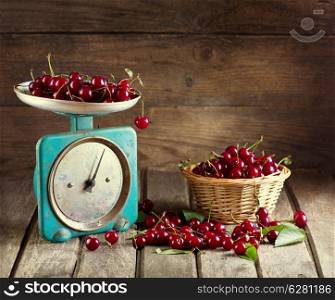 Still life with fresh cherries on wooden background