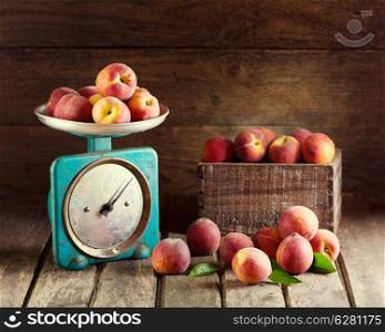 Still life with fresh peaches on wooden background