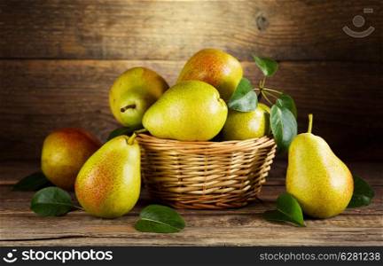 still life with fresh pears on wooden background