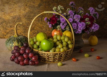 Still Life with Fruit baskets are arranged with a beautiful vase of flowers.