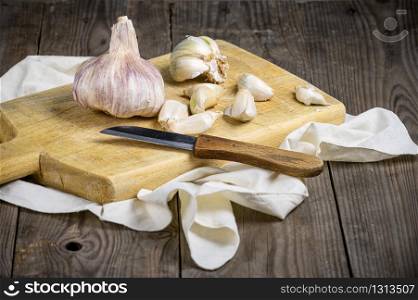 Still life with garlics on rustic wood table .. Still life with garlics on rustic wood table.