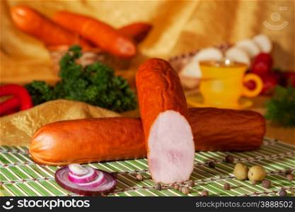 Still life with ham sausage with slice. close-up
