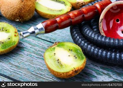 Still life with kiwi hookah. Smoking Turkish hookah with taste of kiwi.Fruit aroma of shisha