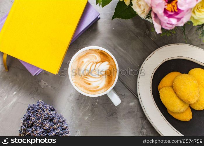 Still life with lavender and cappuccino cup with cookies and books. Cup of lavender cappuccino . Cup of lavender cappuccino