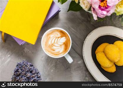 Still life with lavender and cappuccino cup with cookies and books. Cup of lavender cappuccino . Cup of lavender cappuccino