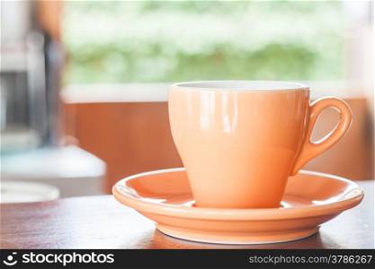 Still life with orange espresso coffee cup, stock photo