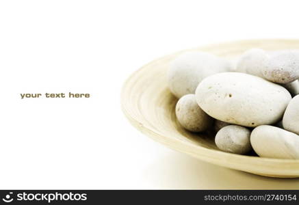 still life with pebbles in bamboo bowl. With sample text