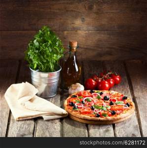 still life with pizza on wooden background