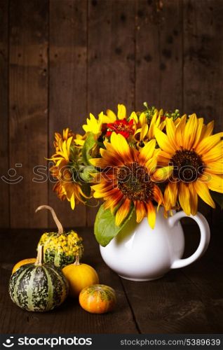 Still life with pumpkins and sunflowers