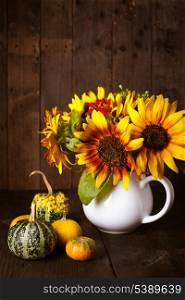 Still life with pumpkins and sunflowers