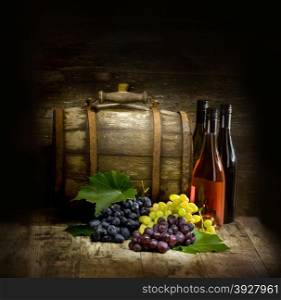 Still life with red and white wine, bottles, grapes and barrel