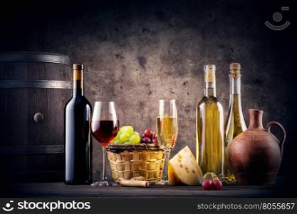 Still life with red and white wine on dark background. Still life with red and white wine