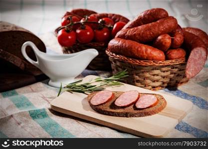 still life with sliced sausage and bread