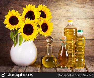 still life with sunflower oil and flowers
