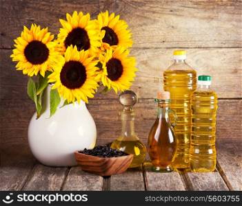 still life with sunflower oil and flowers