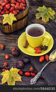 Still life with yellow cup of tea,sipontum,leaves and chestnuts