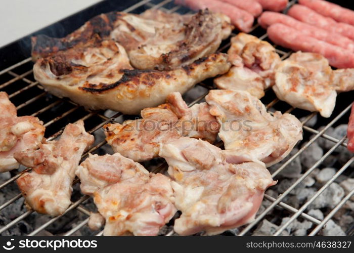 Stilts raw chicken and sausages on the barbecue