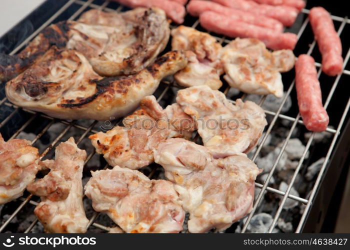 Stilts raw chicken and sausages on the barbecue