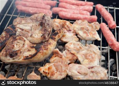 Stilts raw chicken and sausages on the barbecue