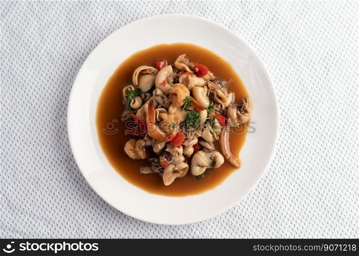 Stir fried basil with squid and shrimp, seafood style Thai food.